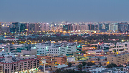 Deira modern and old buildings canal aerial view of Dubai Creek day to night timelapse.