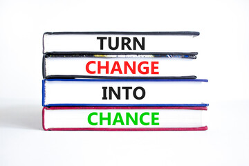 Turn change into chance symbol. Concept words phrase Turn change into chance on beautiful books. Beautiful white paper background. Business Turn change into chance concept. Copy space.