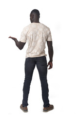 Naklejka premium back view of a man showing an imaginary object in her hand on white background