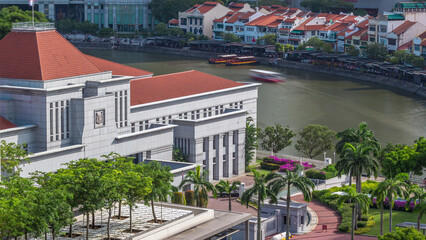 Parliament House in downtown Singapore aerial timelapse and boat quay in the background.