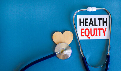 Health equity symbol. Concept words Health equity on beautiful white card. Wooden heart and...
