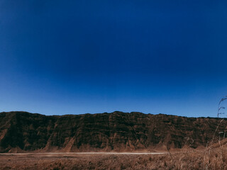 Vast Expanse Majestic Mountain Silhouette Against a Vivid Blue Sky