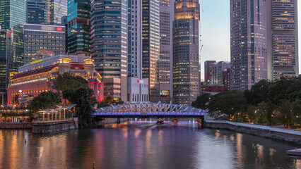 Singapore skyscrapers skyline with white Anderson Bridge near esplanade park day to night timelapse.