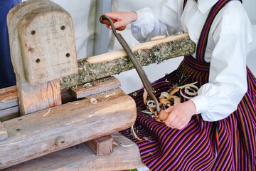 Manual removal of bark from a wooden log. Children's education. Selective focus.