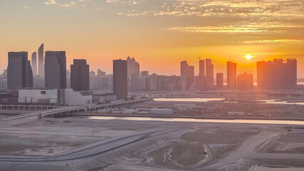 Obraz premium Buildings on Al Reem island in Abu Dhabi at sunset timelapse from above.
