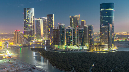 Buildings on Al Reem island in Abu Dhabi day to night timelapse from above.