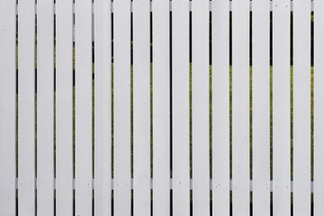 White wooden fence with narrow cracks.