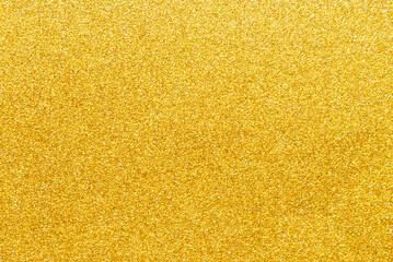 Golden sparkle glitter paper background close up