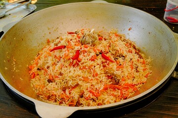 Aromatic Uzbek plov just cooked. Homemade plov with garlic and chili.