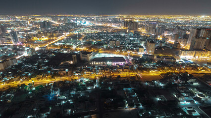 Cityscape of Ajman from rooftop night aerial timelapse