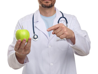 Nutritionist with green apple and stethoscope on white background, closeup
