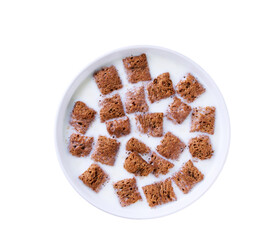 chocolate corn pads  with milk in a bowl isolated on a white background, top view.