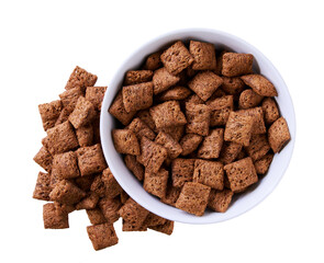 chocolate corn pads pouring out of plate isolated on white background. Top view.