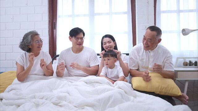 Before putting the kids to bed, parents, grandparents, and kid unwind and play in the bedroom