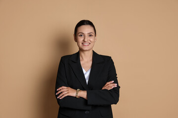 Confident business woman in suit on beige background