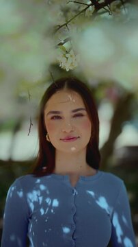 Beautiful young girl smiling warmly at the camera in vertical footage. Natural expression, friendly vibe, perfect for lifestyle, beauty, or personal connection themes