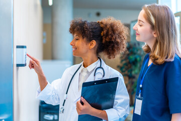 Doctors using keypad access control in hospital corridor