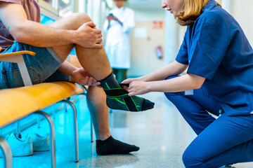 Nurse applying ankle support bandage to patient in hospital