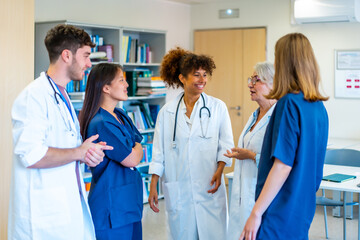 Medical team discussing patient care in hospital corridor