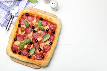 Tasty homemade pizza and cutter on white wooden table, flat lay. Space for text