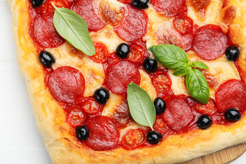 Tasty homemade pizza on white table, top view