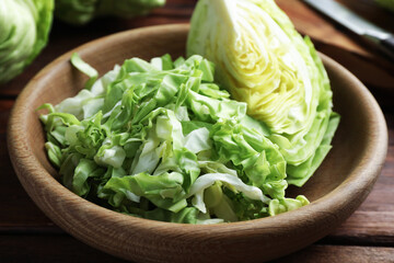 Cut fresh cabbage in bowl on table, closeup