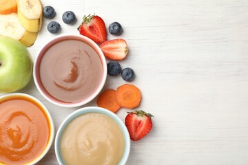 Baby food. Tasty puree in bowls and different ingredients on white wooden table, flat lay. Space...