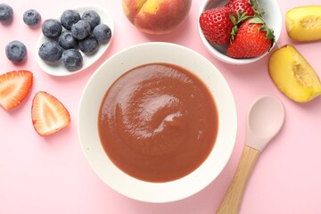 Baby food. Tasty puree in bowl and ingredients on pink background, flat lay