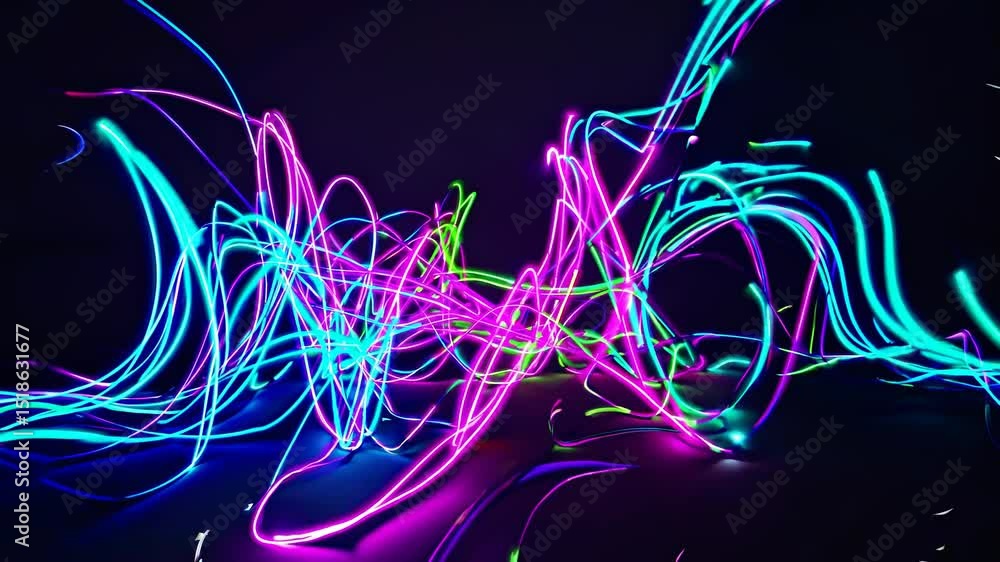 Poster intertwining and swirling bright neon light trails create a vibrant, dynamic abstract composition ag