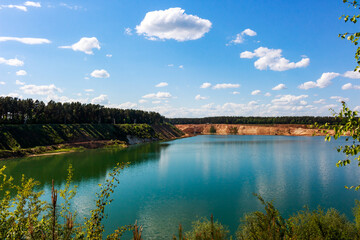 Large sand quarry artificially converted into a lake, panoramic view of the reservoir
