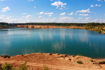 Large sand quarry artificially converted into a lake, panoramic view of the reservoir