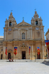 Fototapeta premium Historic Church in Malta With Colorful Flags