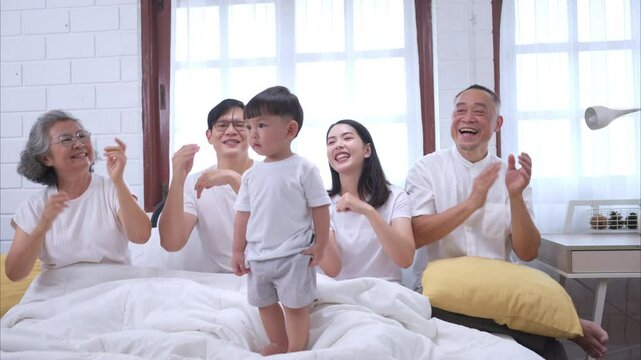 Before putting the kids to bed, parents, grandparents, and kid unwind and play in the bedroom