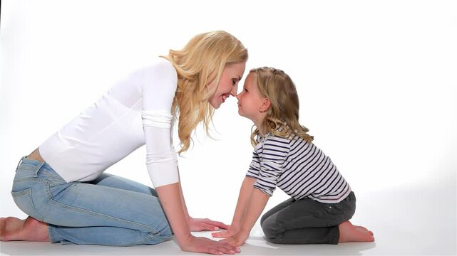 Joyful mother and daughter share an adorable eskimo kiss