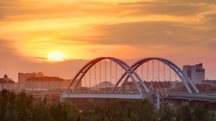 Sunset timelapse above the Bridge with the transport and clouds on the background. Central Asia, Kazakhstan, Astana