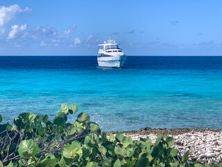 Private yacht floating off the shore of Klein Curaçao with white sand and turquoise water