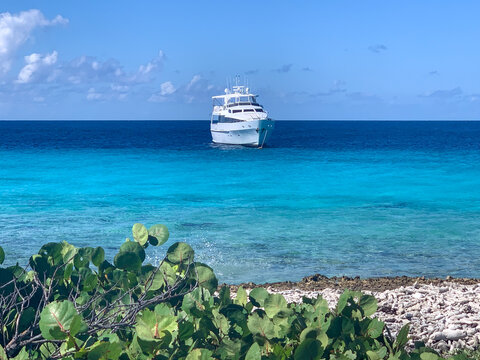 Private yacht floating off the shore of Klein Curaçao with white sand and turquoise water