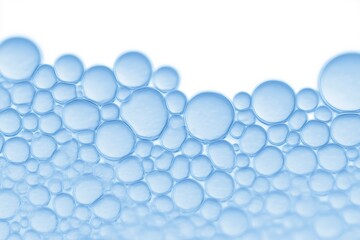 Close-up of translucent blue soap bubbles on a white background, showcasing various sizes and shapes, creating a visually appealing abstract pattern with a sense of freshness