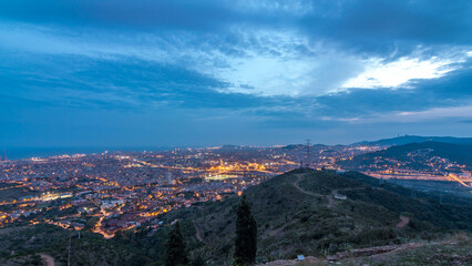 Barcelona and Badalona skyline with roofs of houses and sea on the horizon day to night timelapse