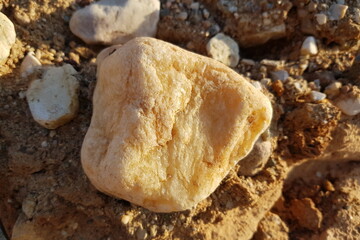Vein quartz boulder in sand and gravel quarry