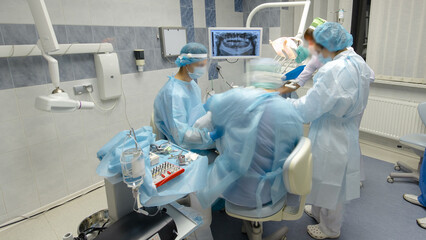 Dentists during surgery for implant placement timelapse.