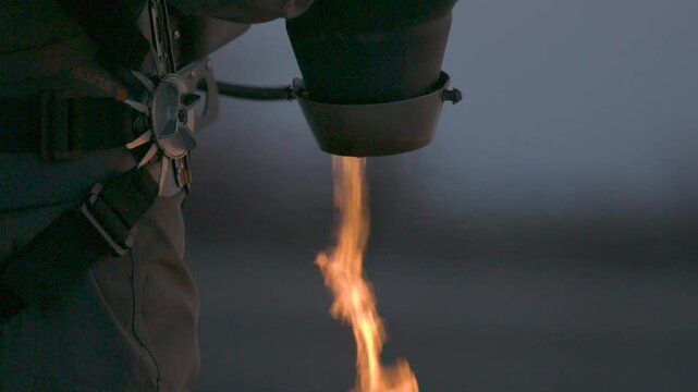 Closeup on jetpack spitting out extremely hot flames