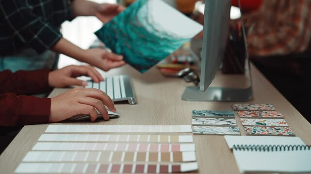 Group of creative professionals collaborating in a bright studio, showcasing color palettes and artistic materials for project development and design inspiration. SACTR