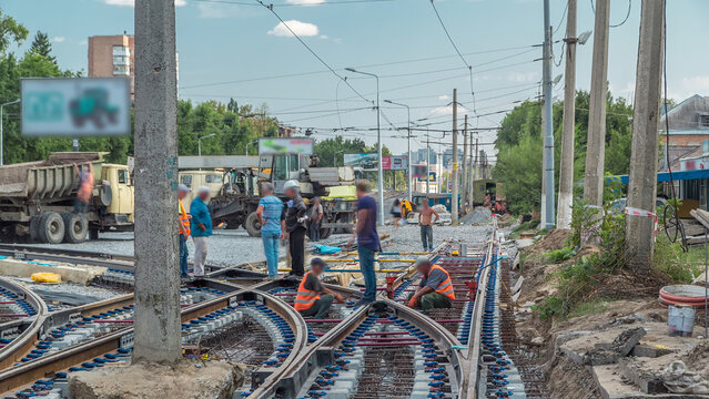 Repair works on the street timelapse. Laying of new tram rails on a city street.