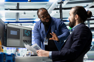 Multiethnic team of engineering specialists working together for solar power manufacturing process, strengthening infrastructure and business development. Renewable energy in a plant.