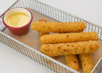 Crispy cheese sticks with sesame seeds and mayonnaise sauce