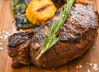 grilled beef steak with vegetable on wood board 