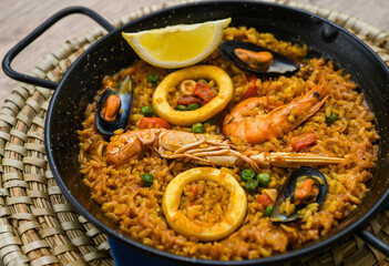 Paella with mussels and shrimps in a pan