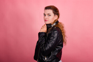 Fototapeta premium Woman with headphones, listening to music, fashion model in studio posing, music genre, smiling, rock, metal music