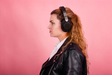 Woman with headphones, listening to music, fashion model in studio posing, music genre, smiling,...